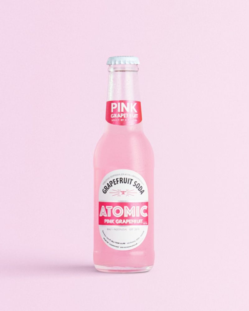 Atomic Pink Grapefruit Soda on a pink background