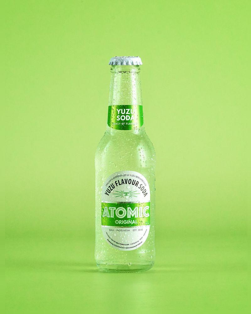 Atomic Yuzu Soda on a green background