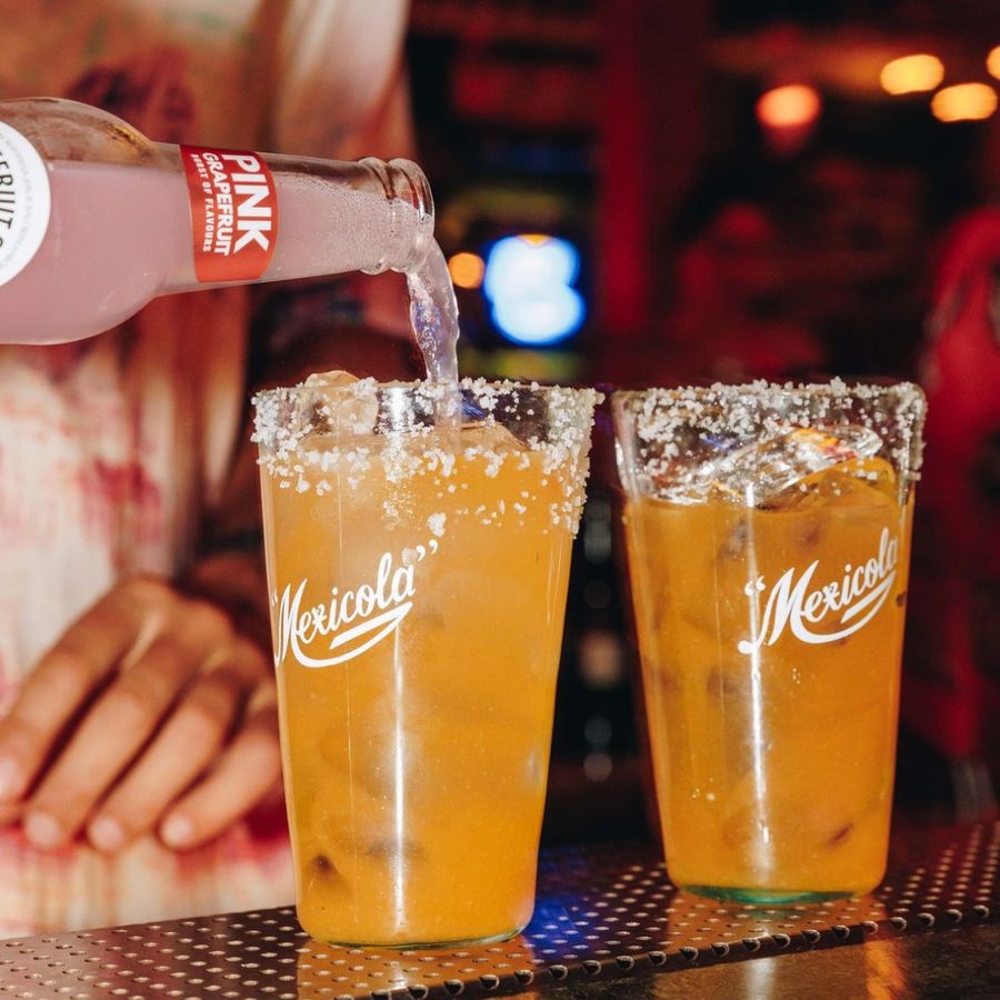 Atomic Pink Grapefruit being poured into salt rimmed cocktails