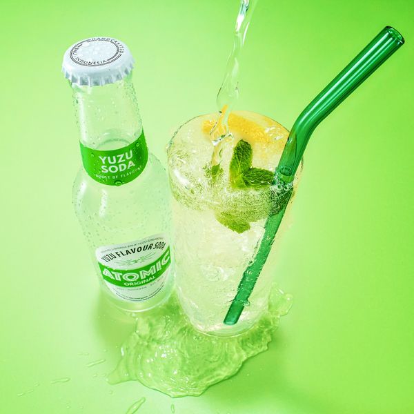 Atomic Yuzu Soda poured into a highball with mint and lemon